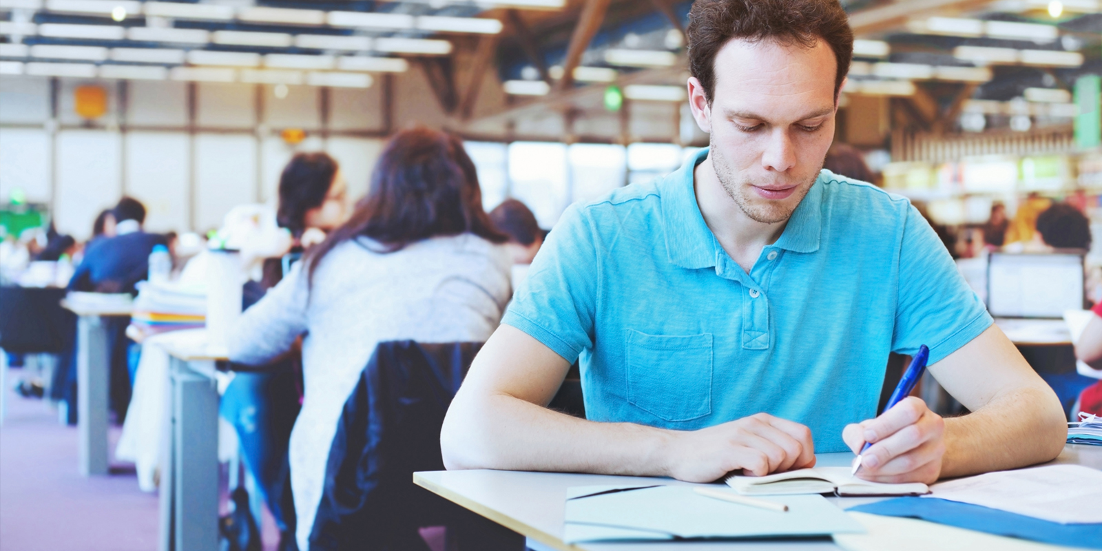 Student working in modern public library of university