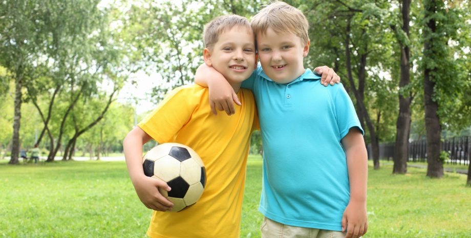 Boys playing soccer in the park