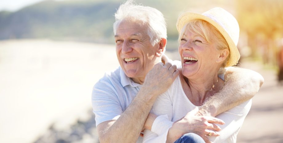Senior couple relaxing by the sea on sunny day
