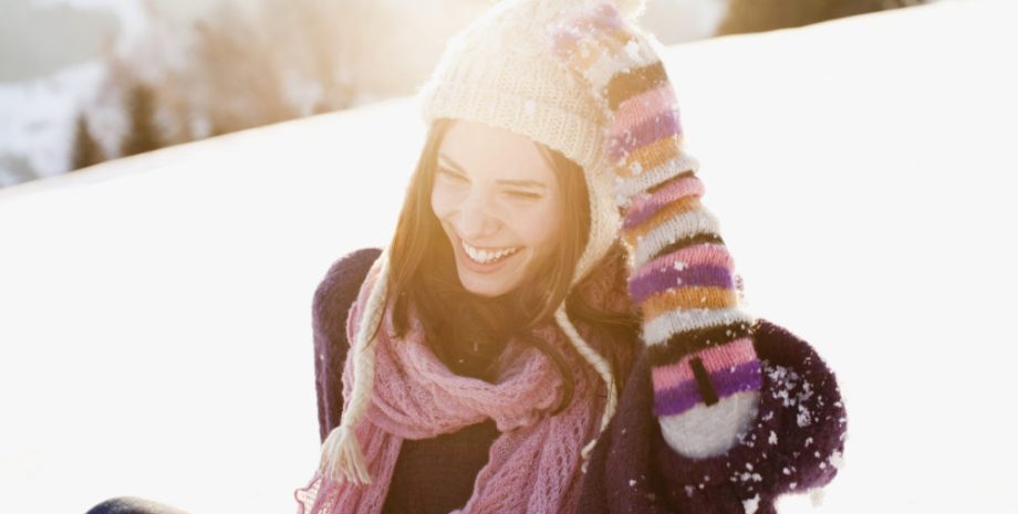 Woman sitting outdoors in snow