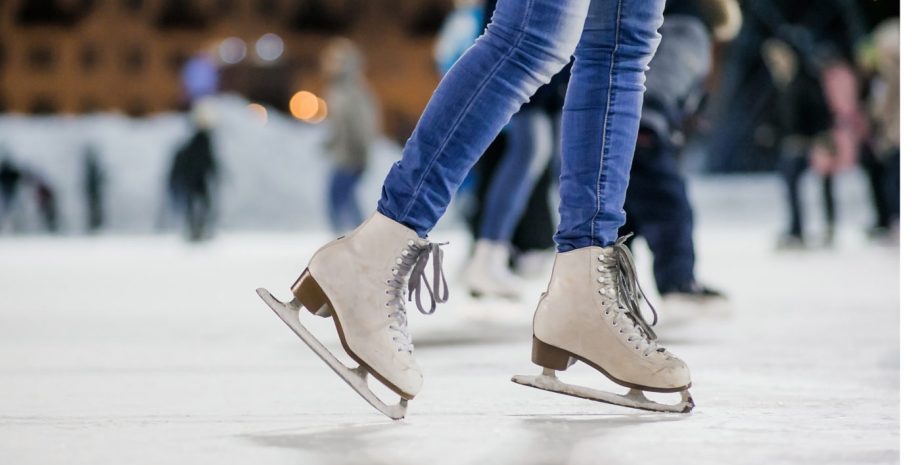 Female's legs shown skating on a skating rink