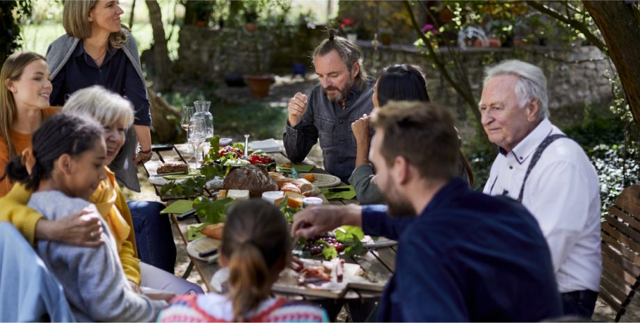 Multi-generational family gathered around a dining table.