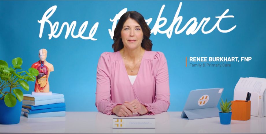 A photo of Renee Burkhart sitting at a desk.