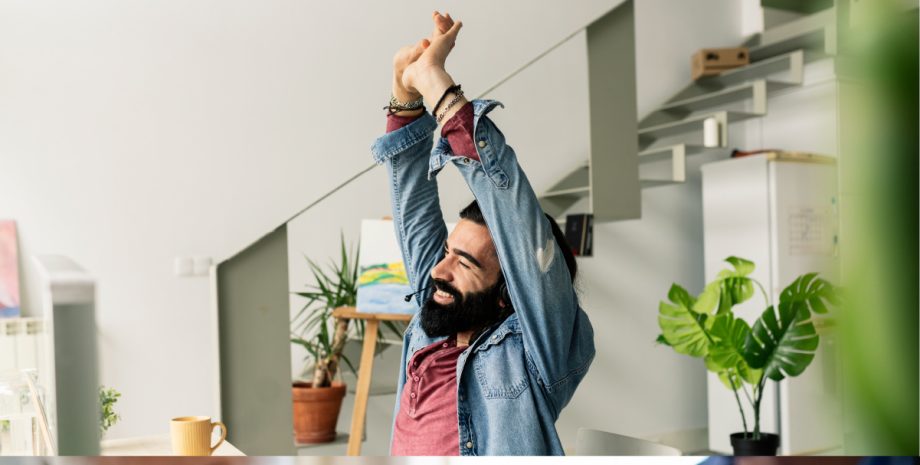 Man stretching arms over head.