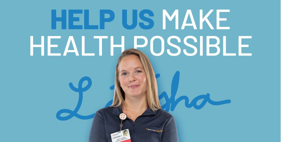 Nurse standing in front of a sign that says 