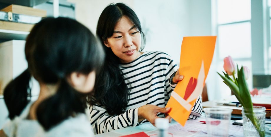 A mother opening a card in front of her child.