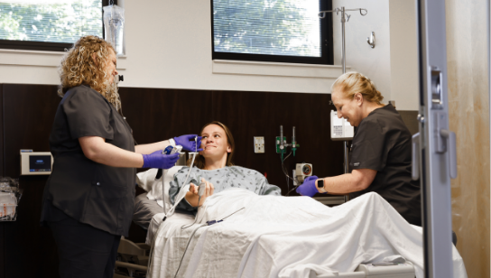 Young female patient getting her temperature taken in a hospital room