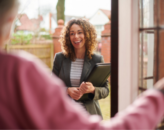 Support navigator with folder speaking to another person at their front door