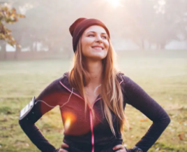 happy young woman standing outside