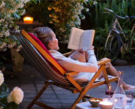 woman relaxing and reading a book outside