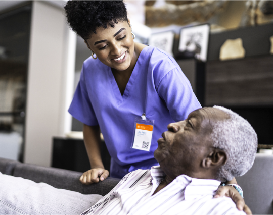 female nurse taking care of a senior man at home