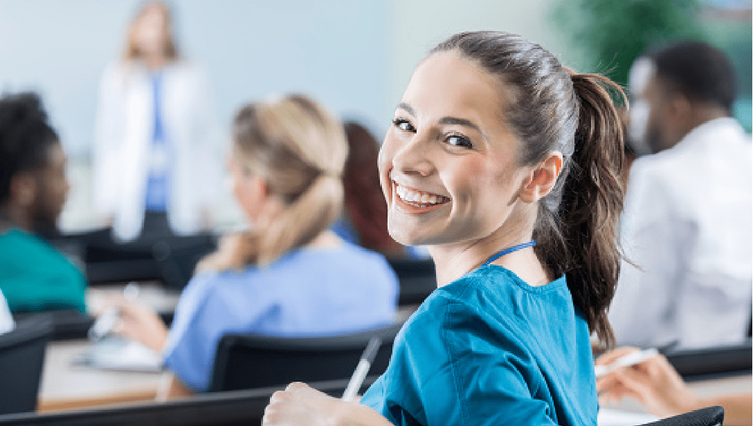 smiling young girl taking notes during job shadowing