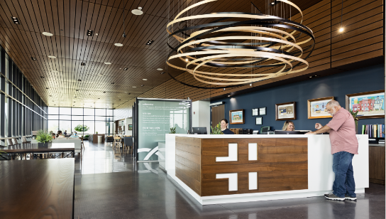man standing at reception desk in the lobby of a Hancock Health location